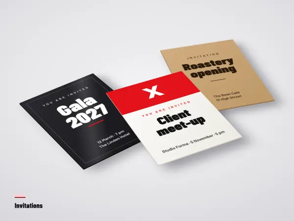 Flat invitations in several sizes laid on a table next to an envelope